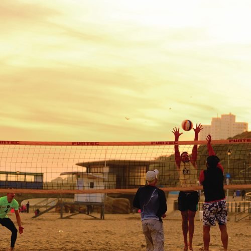 Southbourne students are playing volleyball in Bournemouth beach.